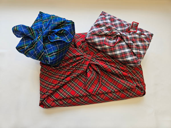 Packages wrapped in plaid coth fabric for gifting