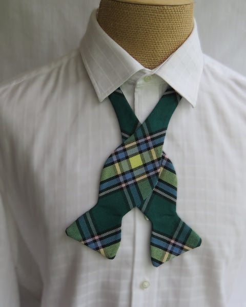 Green plaid bow tie untied on a white shirt made by Taylors Tartans in New Brunswick