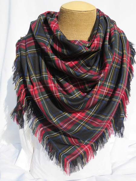 Black and red plaid scarf on a mannequin with a white background