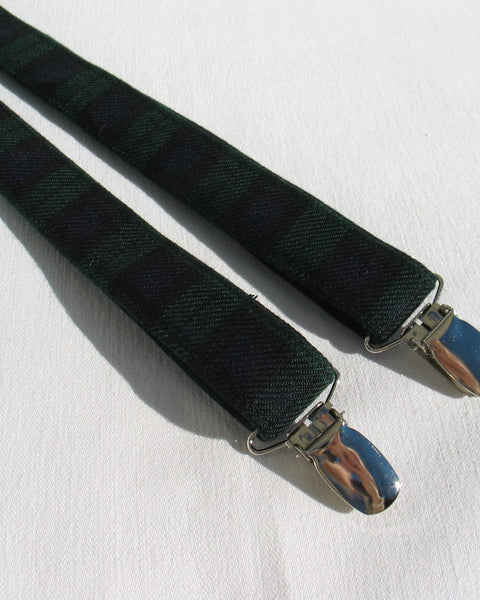 Black watch tartan Black suspenders with silver clips on a white background