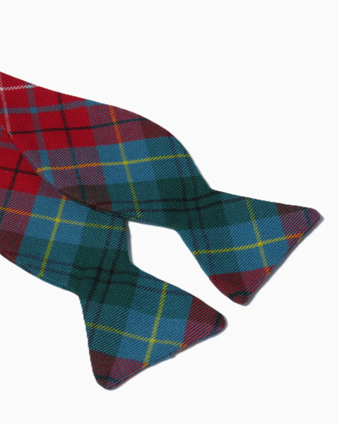 Plaid bow tie with red, blue, and yellow colors on a white background