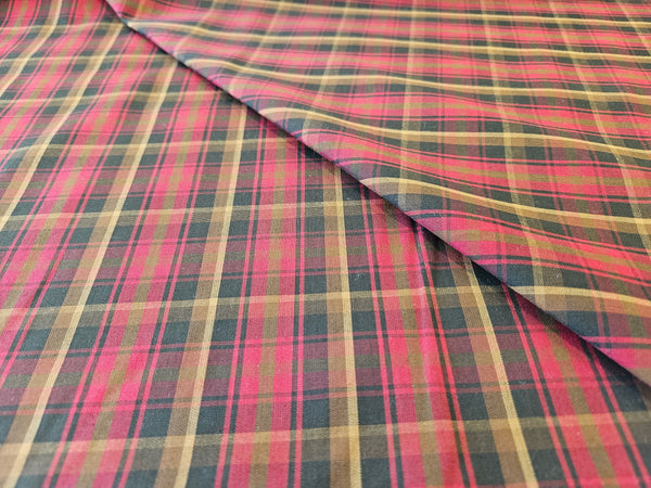 red, browna and green plaid cotton fabric folded over itself sold by Taylors Tartans