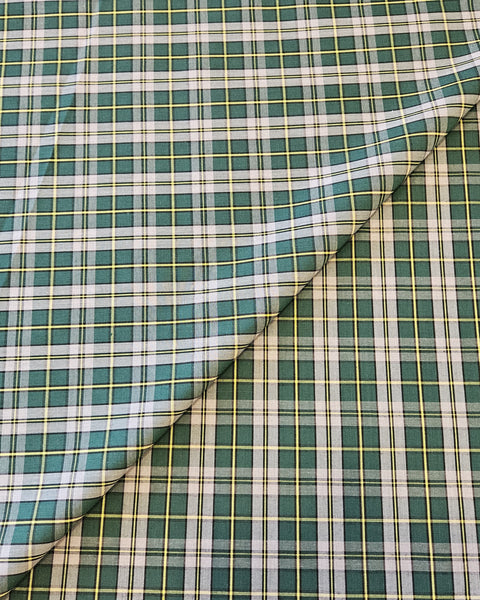 Green, yellow and gray plaid cotton fabric folded with Cape Breton tartan fabric