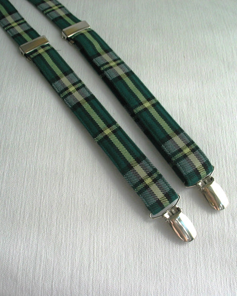 cape breton tartan Green plaid suspenders with silver clips on a light gray background