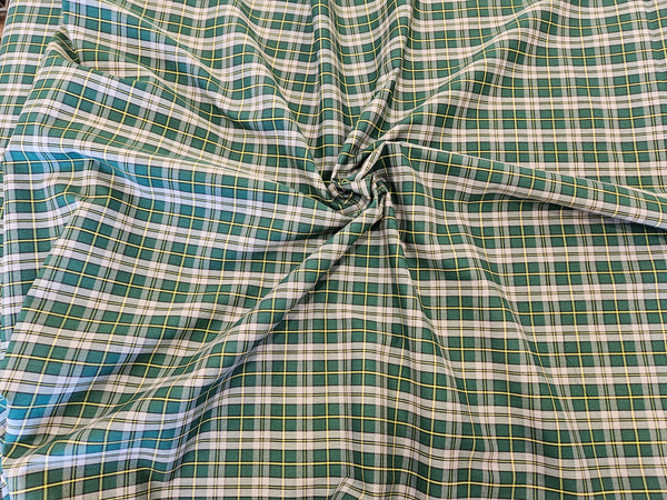 Green, gray and yellow plaid fabric scrunched in Cape Breton by Taylors Tartans.