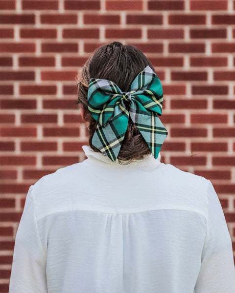 girl wearing a green plaid hair bow in Cape Breton tartan by Taylors Tartans