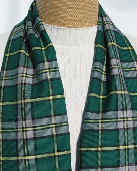 Green plaid scarf draped over a mannequin with a white background