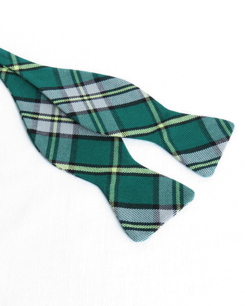 Green plaid Cape Breton tartan self tie bow tie on a white background