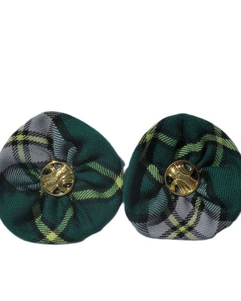 Pair of green plaid shoe clips with gold centers on a white background