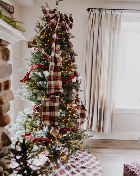 dress stewart tartan christmas tree bow on top of a pre lit christmas tree with a matching tree skirt