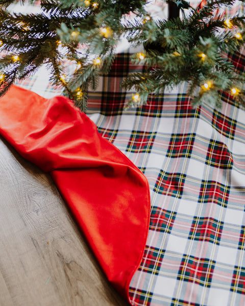 Dress Stewart tartan christmas tree skirt with a red velvet backing underneath a lit tree