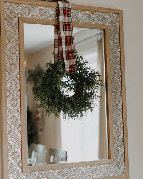 dress stewart tartan ribbon on a wreath in front of a mirror 