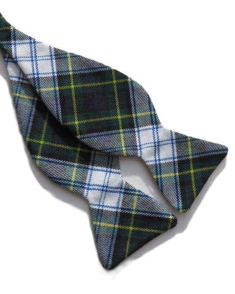 Plaid bow tie with green, blue, and white colors on a white background
