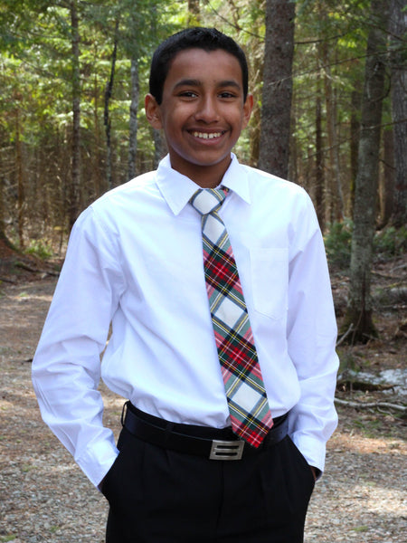 Person wearing a white shirt and  Dress Stewart tartan white and red plaid tie in a forest setting