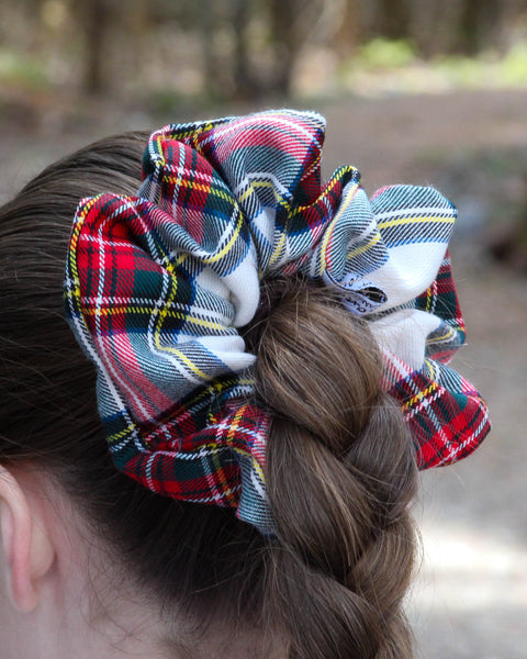 Dress Stewart tartan Plaid scrunchies on a braided hairstyle with a blurred natural background