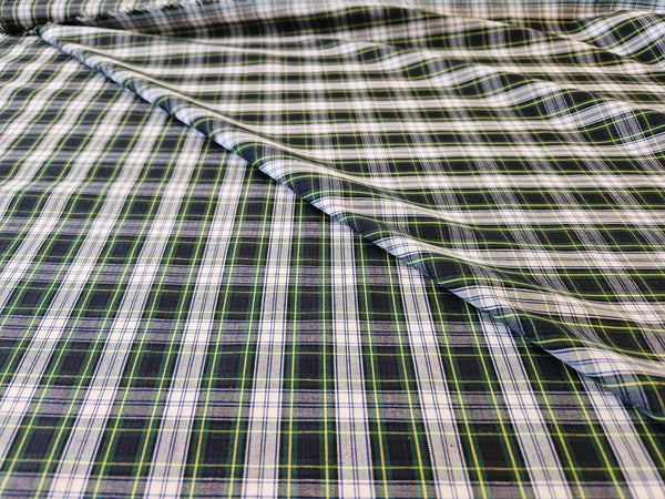 navy, white green and yellow plaid cotton fabric folded over itself made sold by Taylors Tartans