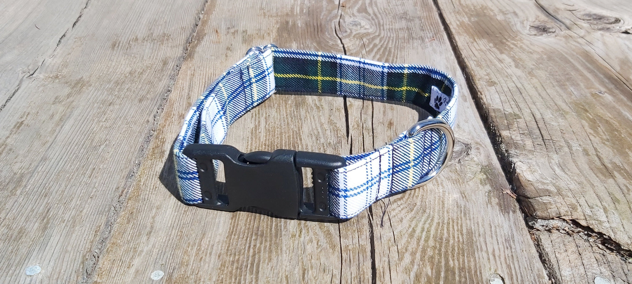 Gordon plaid dog collar laying on weathered boards