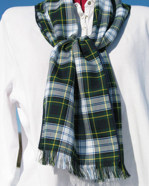 Green plaid scarf on a mannequin with a white shirt and blue sky