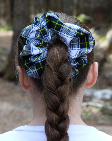Gordon tartan Plaid scrunchie on a braided ponytail with a blurred natural background