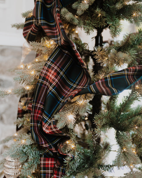 close up of green stewart tartan christmas tree bow tails