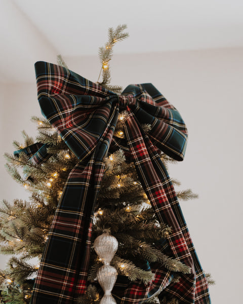 top part of a green stewart tartan green red gold and white plaid christmas tree bow on the top of the tree