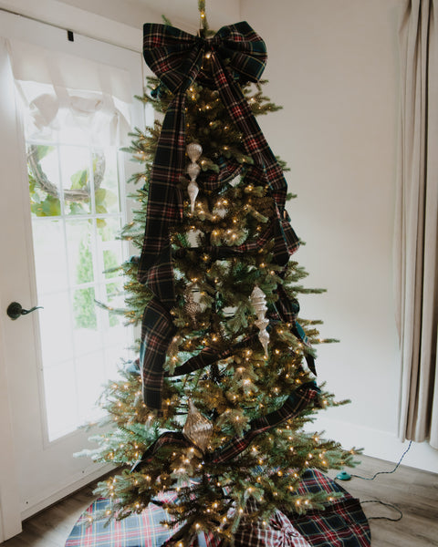 green red white and gold plaid christmas tree bow on a tree