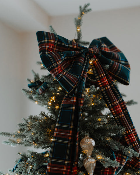 close up of a bow in green red white and gold plaid