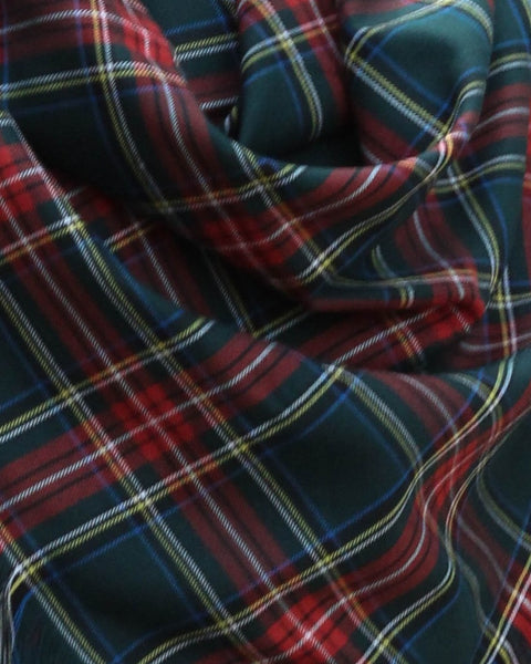 Close-up of plaid fabric with green, red, yellow and white plaid fabric in Green Stewart by Taylors Tartans