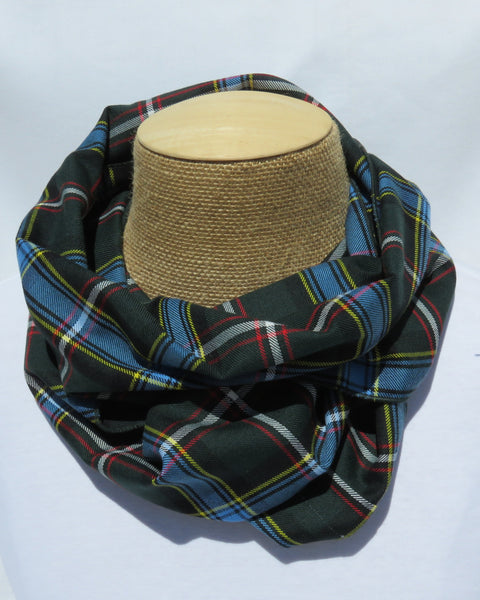 Plaid patterned scarf on a mannequin head against a white background