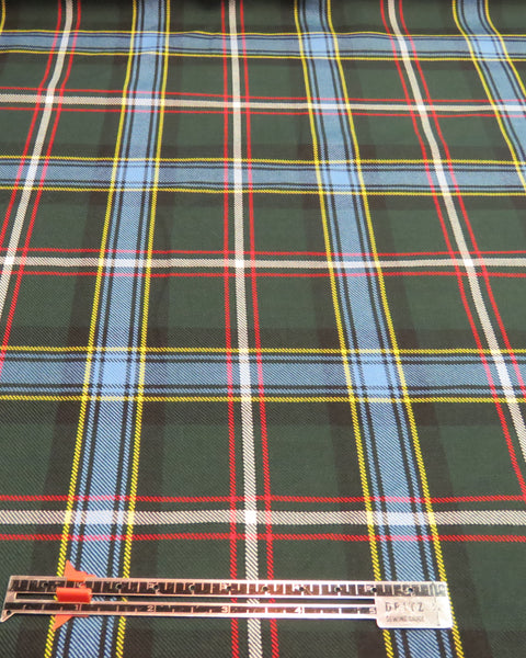 Green and blue plaid fabric with ruler for measuring scale on this Labrador tartan fabric