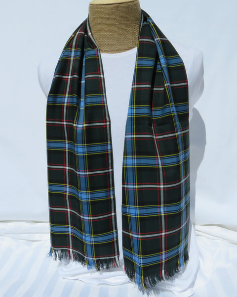 Plaid scarf draped over a mannequin on a white background