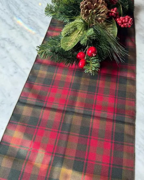 Canadian Maple Leaf tartan Plaid table runner with Christmas decorations on a marble surface