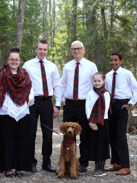Family of five with a dog in a forest setting wearing Maple Leaf taratn