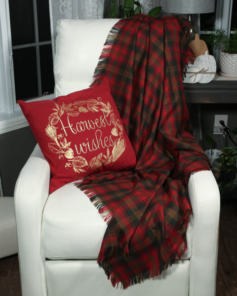 Canadian Maple Leaf Red plaid blanket draped over a white chair with a red pillow featuring 'Harvest Wishes' text.