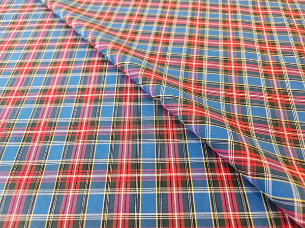 McBeth plaid cotton fabric folded over itself, blue, red, yelow and plack plaid