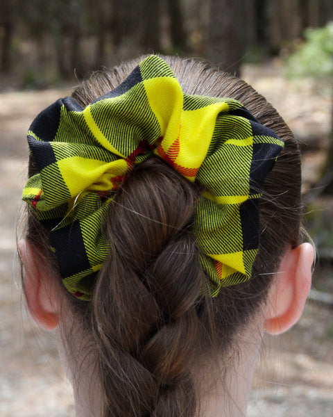 MacLeod of Lewis Plaid scrunchie on braided hair with a blurred natural background