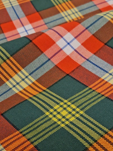 Close-up of a plaid fabric with red, green, blue, and orange colors.