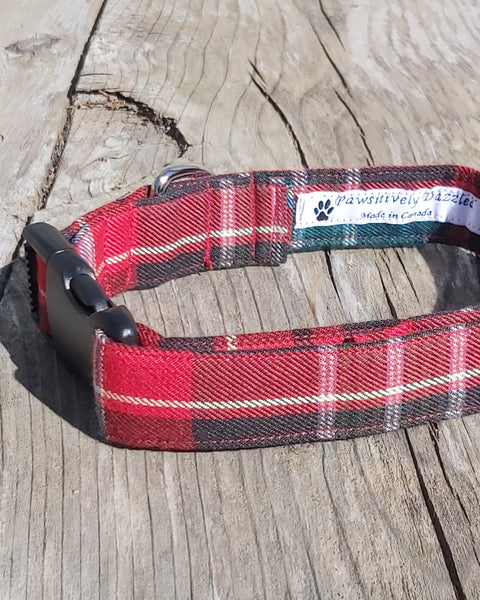 Red plaid dog collar with a brand label on a wooden surface
