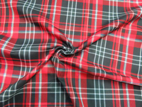 Red, green, and blue plaid fabric scrunched up to show texture and pattern.