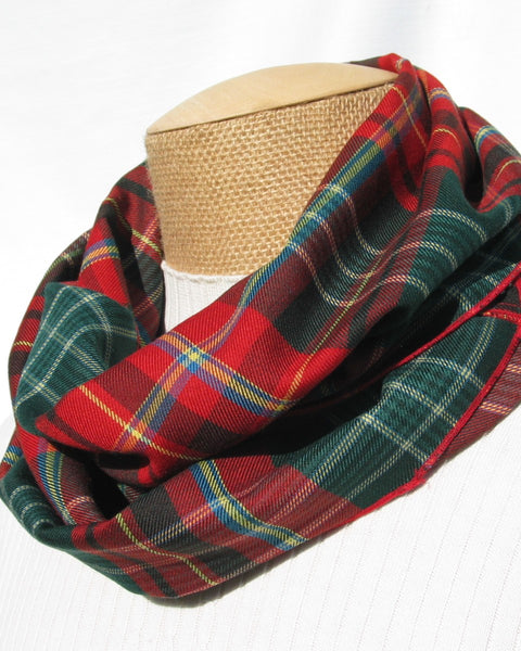 green, red, white, yellow and blue Plaid scarf on a mannequin head against a white background