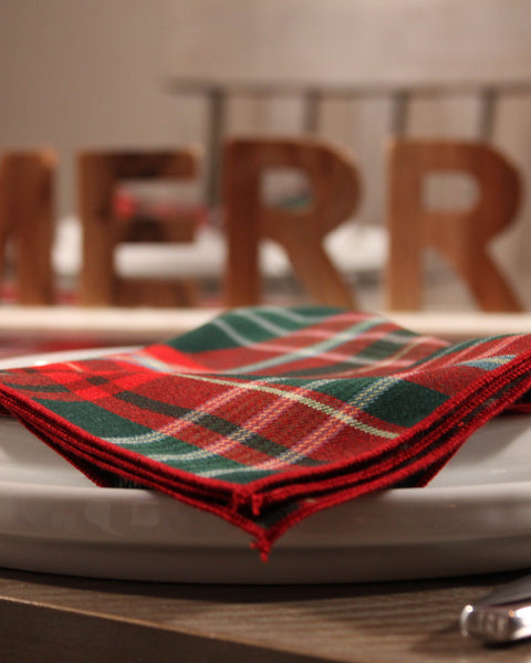 Red green and white tartan napkin on a white plate