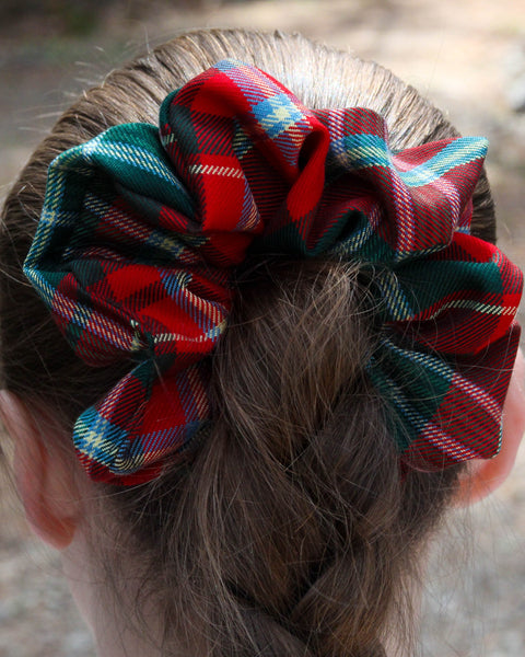 New Brunswick tartan Plaid scrunchie on a bun with a blurred background