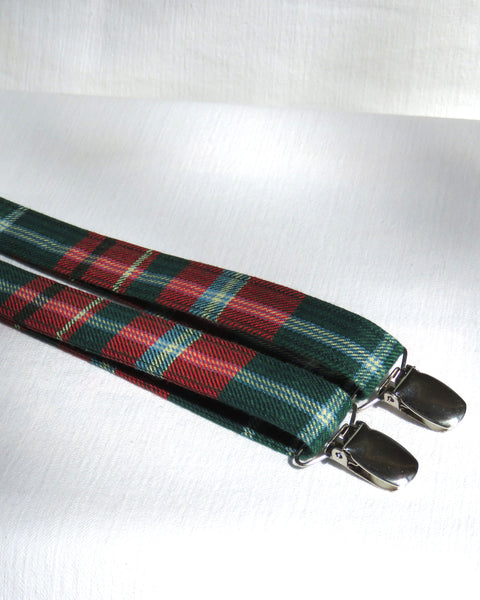 new brunswick tartan Green and red plaid suspenders with silver clips on a white background