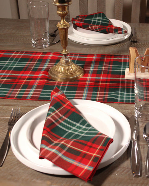 New Brunswick tartan red green and white plaid napkin on a white plate with silverware on a wooden table