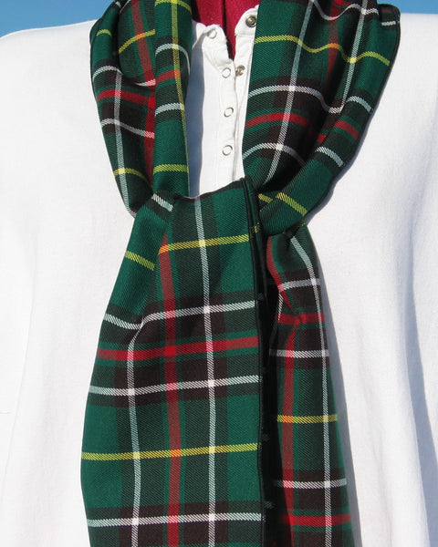 Green plaid scarf draped over a white manequin torso