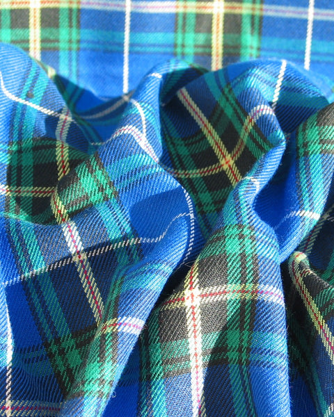 Blue, green and yellow plaid fabric bunched in Nova Scotia tartan fabric