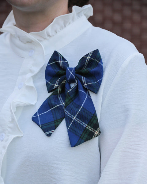 Nova Scotia tartan bow on a white shirt with ruffled collar