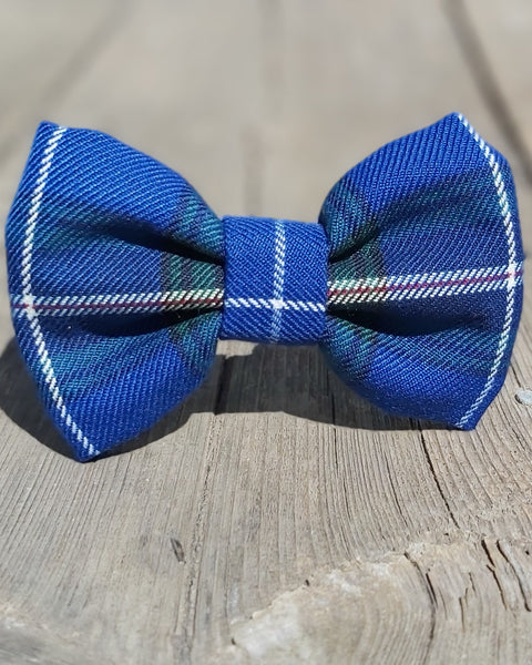 Blue plaid pet bow tie in Nova Scotia tartan on a wooden surface