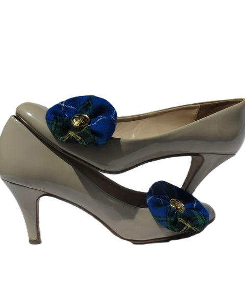 Beige high-heeled shoes with blue Nova scotia tartan floral shoe clips on a white background
