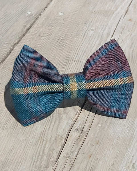 Brown and green plaid bow tie in Ontraio tartan by Taylors Tartans on a wooden surface